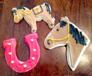 Photo of sugar cookies in the shape of a horse and a horseshoe